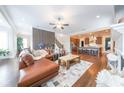 Open-concept living room with hardwood floors, fireplace, and seamless kitchen access at 6626 Sterling Dr, Sandy Springs, GA 30328