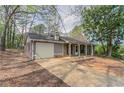 Single-story home featuring an attached garage and a concrete driveway at 1803 Gingham Ct, Lithonia, GA 30058