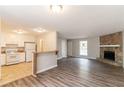 Open concept living area featuring a stone fireplace, and a view to the kitchen at 1803 Gingham Ct, Lithonia, GA 30058