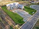 New home under construction with a manicured lawn and a long driveway, aerial view at 225 Maison Court, Roswell, GA 30076