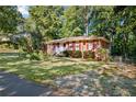 Quaint brick home featuring a well-maintained lawn and landscaping, offering inviting curb appeal at 4535 Forest Green Dr, Sugar Hill, GA 30518