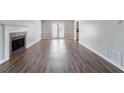 Bright living room with hardwood floors, a fireplace, and a door to the back at 2030 Hilda Burns Pl, Lithonia, GA 30058