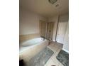 Bathroom featuring a soaking tub with tiled surround and a glass-enclosed shower at 2114 Westhill Dr, Smyrna, GA 30082