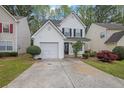 Charming two-story home with a manicured lawn, one-car garage, and inviting front porch at 240 Springbottom Ct, Lawrenceville, GA 30046