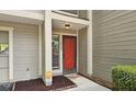 Charming front entrance showcasing a vibrant red door and modern security system at 2929 Torreya Se Way, Marietta, GA 30067