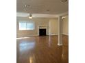 Bright living room featuring hardwood floors, a cozy fireplace, and abundant natural light at 2929 Torreya Se Way, Marietta, GA 30067