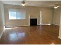 Bright living room featuring hardwood floors, a fireplace, and a large window with natural light at 2929 Torreya Se Way, Marietta, GA 30067