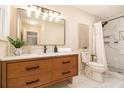 Well-lit bathroom featuring a new vanity, and a tile surround walk-in shower with decorative, neutral finishes at 9640 Cedar Grove Rd, Fairburn, GA 30213