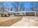 Charming single-story home with attached carport and freshly painted exterior, set on a spacious lot with mature trees at 9640 Cedar Grove Rd, Fairburn, GA 30213
