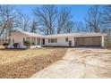 Charming white brick ranch home with attached carport and a well kept lawn at 9640 Cedar Grove Rd, Fairburn, GA 30213