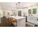 Modern kitchen featuring a large island, stainless steel appliances, and hardwood floors at 9640 Cedar Grove Rd, Fairburn, GA 30213