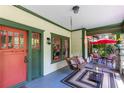 Inviting front porch with a porch swing, seating area, and red accents for a cozy, comfortable outdoor space at 966 Blue Ridge Ne Ave, Atlanta, GA 30306