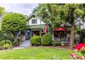 Green lawn leading to a charming home with a cozy front porch and outdoor seating area at 966 Blue Ridge Ne Ave, Atlanta, GA 30306