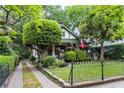 Beautiful landscaped front yard with a brick-lined walkway and dark metal fence surrounding a cozy craftsman home at 966 Blue Ridge Ne Ave, Atlanta, GA 30306