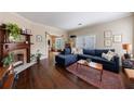 Inviting living room featuring hardwood floors, a fireplace, and a comfortable blue couch at 1027 Kirkwood Se Ave, Atlanta, GA 30316