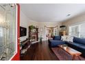 Comfortable living room with dark hardwood floors, a fireplace, and a large blue couch at 1027 Kirkwood Se Ave, Atlanta, GA 30316