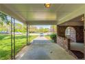View of the carport, showcasing brick columns and a view of the front yard and driveway at 2877 Kensington Way, Rex, GA 30273