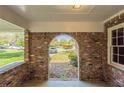 Brick archway detail of the carport, with a view of the street and front yard beyond at 2877 Kensington Way, Rex, GA 30273