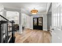 Stunning entryway featuring wood floors, decorative columns, and abundant natural light at 1004 Windermere Xing, Cumming, GA 30041