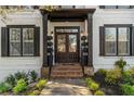 Inviting front entrance featuring double doors, brick steps, and manicured landscaping at 1004 Windermere Xing, Cumming, GA 30041