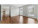 Sunlit bedroom showcasing gleaming hardwood floors and neutral paint at 135 S Falcon Blf, Alpharetta, GA 30022