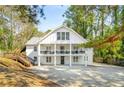 Charming two-story home with a classic white exterior, complemented by a covered balcony and a neatly landscaped front yard at 1596 Willowbrook Sw Dr, Atlanta, GA 30311