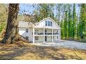 Charming white two-story home featuring double balconies and stairs to backyard at 1596 Willowbrook Sw Dr, Atlanta, GA 30311