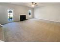 Spacious living room with cozy fireplace, neutral carpet, and door to backyard at 501 Fable Ln, Canton, GA 30114