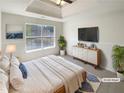 Calming main bedroom with tray ceilings, large windows, and modern décor at 501 Fable Ln, Canton, GA 30114