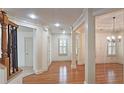 Bright hallway with hardwood floors, crown molding, and elegant lighting fixtures at 625 Aunt Lucy Ln # 45, Smyrna, GA 30082