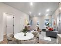View of dining area flowing into living room featuring modern decor and hardwood flooring at 1005 Sims Nw Ave, Atlanta, GA 30318