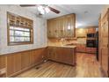 Charming eat-in kitchen featuring wooden cabinets, hardwood floors, and vintage wallpaper at 1470 Biltmore Ne Dr, Atlanta, GA 30329