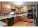 Well-lit kitchen with wooden cabinets, stainless steel appliances, and hardwood floors at 1470 Biltmore Ne Dr, Atlanta, GA 30329