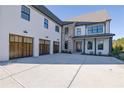 Beautiful exterior with a three-car garage and manicured landscaping at 2875 Caney Parc Way, Cumming, GA 30041