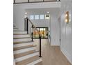 Elegant staircase with modern railings and hardwood floors at 2875 Caney Parc Way, Cumming, GA 30041