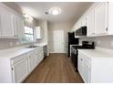 Spacious kitchen features white cabinets and stainless steel appliances at 2910 Treehouse Ln, Lawrenceville, GA 30044