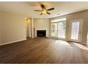 Bright living room features a fireplace, fan and beautiful windows at 2910 Treehouse Ln, Lawrenceville, GA 30044