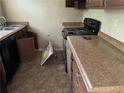 Functional kitchen space with appliances and ample countertop space, ready for updates at 6127 Pinegrove Rd, Riverdale, GA 30274
