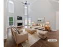 Staged living room with high ceilings, a fireplace, lots of natural light, and hardwood floors at 2123 Tigger Ne Trce, Marietta, GA 30066