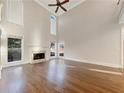 Bright living room featuring tall ceilings, hardwood flooring, and a cozy fireplace at 2123 Tigger Ne Trce, Marietta, GA 30066