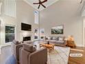 Bright living room with high ceilings, fireplace, and picture windows, virtually staged for modern living at 2123 Tigger Ne Trce, Marietta, GA 30066