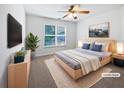 Nicely decorated main bedroom featuring neutral decor, a ceiling fan, and a bright window at 2123 Tigger Ne Trce, Marietta, GA 30066