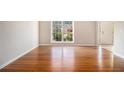 Spacious living room featuring sleek wood floors and plenty of natural light at 3707 Mcguire Nw St, Kennesaw, GA 30144
