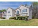 Lovely two-story home with a manicured lawn, complemented by lush greenery and a two-car garage at 4097 Rosebud Park Dr, Snellville, GA 30039