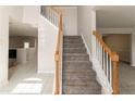 Inviting foyer with a carpeted staircase and wood railing leading to the upper level at 4097 Rosebud Park Dr, Snellville, GA 30039