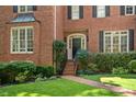Elegant brick home with a manicured lawn leading to a welcoming front door at 788 Old Paper Mill Dr, Marietta, GA 30067