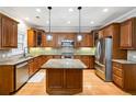 Gourmet kitchen with wooden cabinets, stainless steel appliances, and granite countertops at 3317 Regent Sw Pl, Atlanta, GA 30311