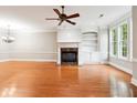 Bright living room with hardwood floors, fireplace and built-in shelves, perfect for entertaining at 3317 Regent Sw Pl, Atlanta, GA 30311