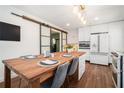 Eat-in kitchen featuring a rustic wood dining table and modern stainless steel appliances at 403 Red Oak Ln, Lawrenceville, GA 30046