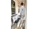 Inviting front porch featuring a bench with floral pillows and a modern hanging light fixture at 403 Red Oak Ln, Lawrenceville, GA 30046